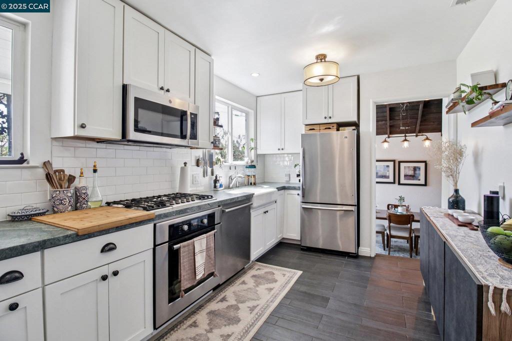 Welcome to this charming oasis, where modern comfort meets outdoor serenity. This beautifully upgraded 2-bed, 1-bath home offers the perfect blend of convenience and tranquility. Just a short walk to BART and centrally positioned for easy Bay Area commuting, this home is as practical as it is peaceful. Enjoy the added flexibility of a permitted 120 sq ft detached ADU, perfect as a home office, creative studio, or even an extra bedroom. Move-in ready with fresh interior paint, a new two-car driveway, and a modern sprinkler system for the lush backyard lawn. Productive edible garden – pick your own organic apples, peaches, persimmons, oranges, plums, grapefruit, pomegranates, figs, guavas, grapes, and berries—all maintained with efficient drip irrigation. Relax or host guests on a spacious backyard patio, surrounded by native landscaping and the sweet scent of night-blooming jasmine. Whether you're working from home, entertaining outdoors, or enjoying fresh fruit from your own garden, this one-of-a-kind San Leandro home offers it all. Don't miss out!