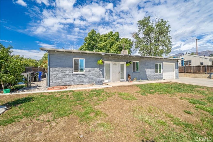 Welcome to this charming 4-bedroom, 1-bath home located in the beautiful city of Yucaipa. Step inside to a spacious living room that flows seamlessly into the kitchen and dining area, perfect for gatherings and everyday living. The home features laminated flooring throughout, an updated bathroom, and a kitchen with plenty of counter space for cooking and entertaining. Outside, you’ll find a large front yard and an expanded driveway offering additional parking, including space for an RV. With its great layout and practical updates, this home is move-in ready and waiting for its new owners. Conveniently located near schools, shopping, and freeway access, this property is a must-see!