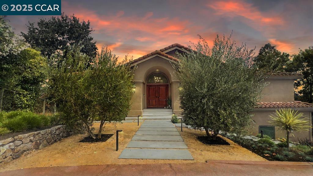 Exquisite 4BD/4BA Custom Estate w/ Italian Elegance, Modern Luxury & private ADU/Studio. Tucked away at the end of a private lane, this one-of-a-kind stunning residence gracefully combines timeless Italian architectural influences w/ refined modern design. Expansive windows showcase sweeping views of the Diablo Valley & surrounding hills, complemented by textures & finishes that unite classical elegance w/ sleek modern aesthetic. The heart of the home features a Striking Porcelanosa-designed kitchen, complemented by high-end Miele appliances & JennAir cooking equipment, opens to a large deck, perfect for entertaining or enjoying the views. A California Closets walk-in & a spa-like primary bathroom create a serene retreat, while the primary suite fireplace & private deck overlooking magnificent vistas elevate the sense of indulgence. Distinctive finishes abound, including handcrafted walnut flooring, custom iron railings, handmade feature tiles, media room, wine room, & an Italian mosaic floor centerpiece. A rare 480 SqFt. ADU w/ its own garage provides versatility for guests, family, office, or rental income. The yard is framed by spectacularly manicured landscaping, creating a tranquil setting. This home is more than a residence—it is a work of art, a sanctuary, & a lifestyle
