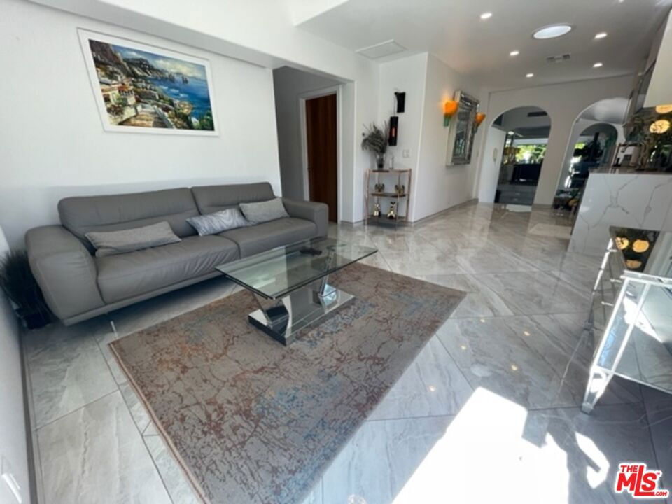 Welcome to a captivating coastal retreat in the prestigious Playa del Rey. This meticulously designed duplex combined as a single home offers a harmonious blend of sophistication and comfort, with its standout features being the exquisite marble floors that grace the living spaces and an outdoor hot tub. Upon entering, you are immediately greeted by the timeless allure of marble underfoot, leading you through the expansive living areas. The gourmet kitchen, adorned with top-of-the-line appliances and marble countertops, is a haven for culinary enthusiasts. Complete with an entertainment bar. Indulge in the epitome of relaxation within either of the master suites with ensuite bathrooms with Steam rooms, resplendent with opulent fixtures and steam showers. Beyond the interiors, this residence unfolds into a private oasis with a meticulously landscaped backyard and a secluded patio. Ideal for entertaining. Only minutes to the beach and a short drive to Manhattan Beach, Playa Vista, Venice, Santa Monica, LAX, Marina Del Rey, Beverly Hills and Downtown. Other attractions include Marina City Yacht Club, Sofi Stadium, Intuit Dome, the Forum and Manhattan Beach Tennis Club. Can be sold furnished for an additional cost. All wall sconces are excluded from sale.