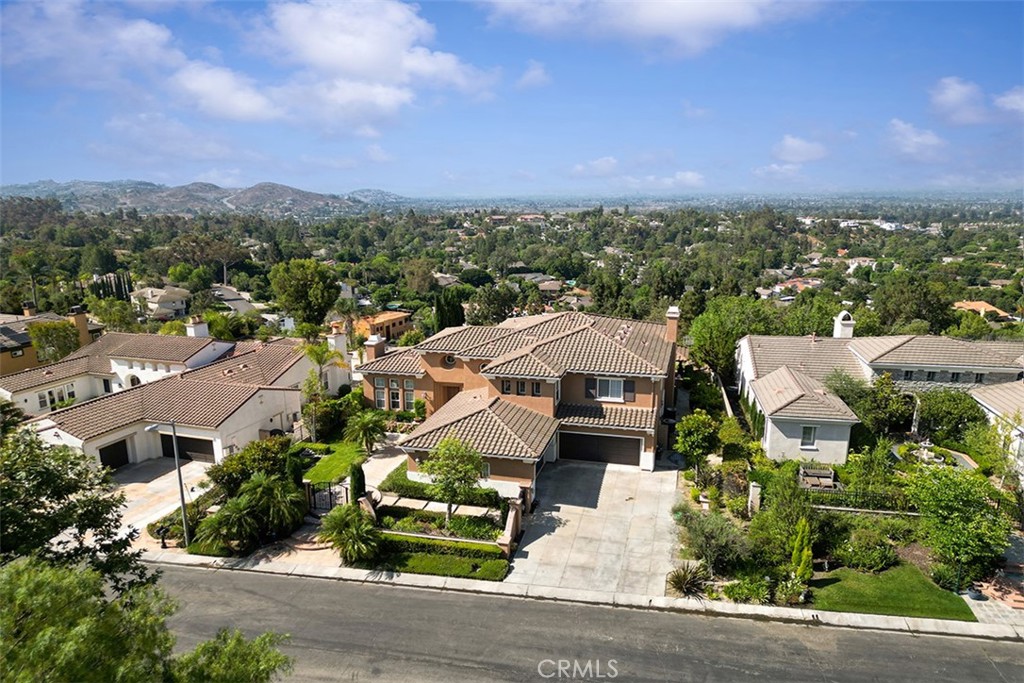 Welcome to 2528 N San Miguel Dr, located in the prestigious gated community of Portofino Estates in Orange, CA. This beautifully upgraded residence offers over 3,800 square feet of luxurious living space with 5 spacious bedrooms and 4.5 bathrooms, sitting on nearly half an acre of private, view-enhanced land. The home features soaring ceilings, a grand marble entry, elegant finishes, a chef’s kitchen with stainless steel appliances, and a spacious master suite with breathtaking city-light and hill views. Located within the highly rated Orange Unified School District, this home is just minutes from Serrano Elementary, Cerro Villa Middle School, and Villa Park High School. Enjoy close proximity to outdoor recreation at Irvine Regional Park, Santiago Oaks, and Oak Canyon Nature Center. Daily conveniences, dining, and shopping are easily accessible at the nearby Crossroads Shopping Center, with grocery stores, cafes, and restaurants all within a few miles. Commuters will appreciate quick access to the 55 and 91 freeways and John Wayne Airport. Whether you're looking for peace, privacy, or a vibrant family community, this home delivers it all in one of Orange’s most desirable gated neighborhoods.