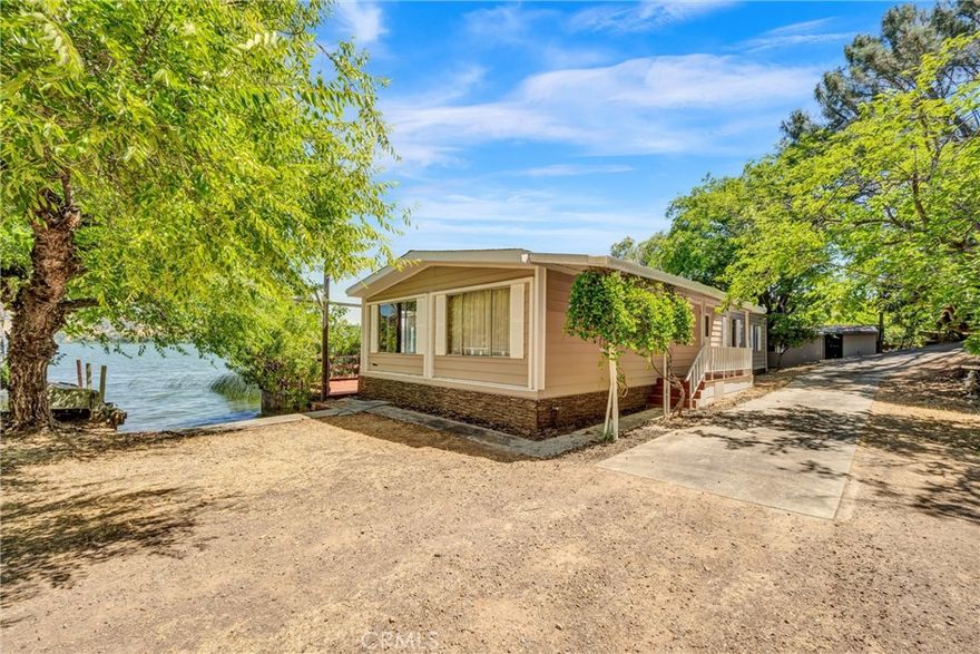 Enjoy lakefront living in this 1980 manufactured home on a permanent foundation with a 1-car garage. This home is on North Drive, located on deep-water. Take in incredible views from your private pier and launch your boat from your own ramp. Thoughtful upgrades include a newer roof, mini-split heating and cooling, new skirting, new water pump, and new shutters. A drip irrigation system draws directly from the lake to keep landscaping lush. The neighboring home is also for sale—offering the perfect opportunity to create a family compound or weekend retreat. A true gem for lake enthusiasts seeking comfort and convenience.