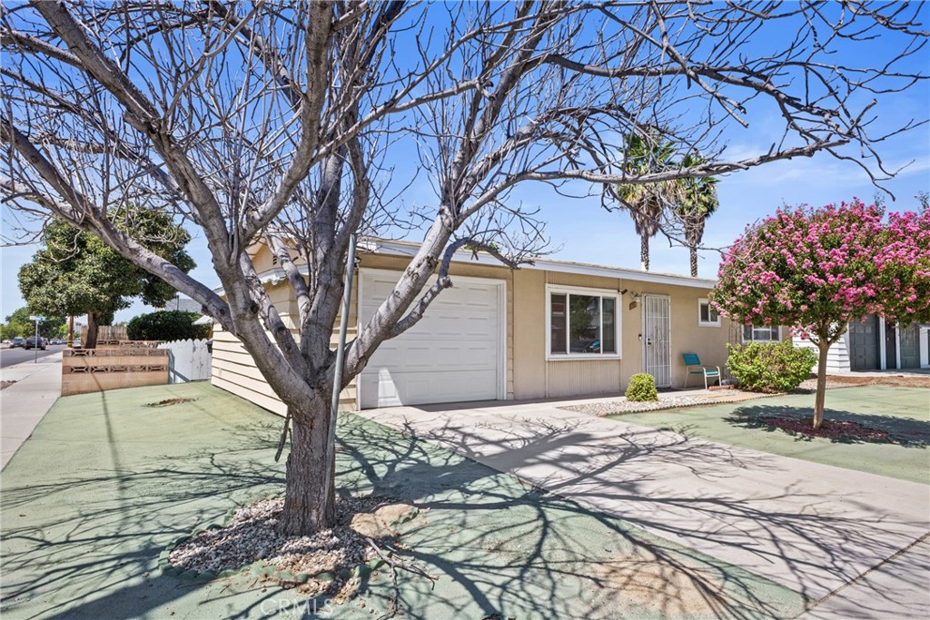 Welcome to Sun Park Hemet II, a 55+ community offering comfort and convenience. This single-level corner home features a low-maintenance yard with hardscape, mature hedges, and a citrus tree in the backyard. Inside, you’ll find laminate flooring in the main living areas, updated bathrooms, and an upgraded kitchen with quartz countertops, tile backsplash, and stainless steel appliances. The inviting living and dining spaces are accented with wainscoting, while the enclosed sunroom provides a flexible space for an office, hobby room, or relaxation area. The backyard is block-fenced, with shade provided by the citrus tree. The laundry room features additional cabinet storage and is conveniently connected to the garage for easy access. Centrally located near main thoroughfares, shopping, dining, and medical offices, this home is a great opportunity for active adults seeking a low-maintenance lifestyle at an affordable price.