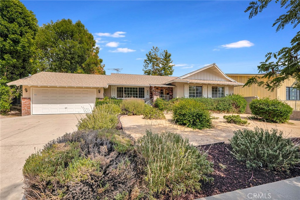 Step into possibility with this single-story 3 bedroom, 2 bath ranch-style retreat in desirable West Hills, offering 1,622 sq ft of living space on an oversized 11,320 sq ft lot. Great curb appeal with uncluttered, drought conscious landscaping and a façade that embraces mid-century charm. This well-cared for home has been freshened up with interior paint and brand new LVT flooring and is move-in ready yet brimming with opportunity to make your own. The stained-glass front opens directly into the formal living room with a large front picture window. The large archway leads on into an open plan informal living area boasting vaulted ceilings and an impressive stone fireplace which becomes the centerpiece for gatherings. An adjoining den/dining area addition expands the living space and offers sliding glass door access to the back patio. The kitchen blends functionality and character with stained-glass accents, wood cabinets, granite/stone counters, recessed lighting, and a handy passthrough. A dedicated laundry room, just off the kitchen, adds functionality and leads to a comfortable ¾ bath with tile surround. Down the hall are 3 good sized bedrooms, two of which share an updated, full, hall bath with beautiful granite surround. The large, primary bedroom offers a vanity area and private access to the ¾ bath. The home offers an attached 2-car garage with direct access. Outdoors, enjoy California living with generous patio area, mature and verdant landscaping, a large in-ground pool, a park-like setting with drought considerate turf and landscaping, creating a space perfect for relaxing weekends, lively entertaining, and ample room to customize to your style of living. Well-situated in a friendly residential neighborhood, near a wide variety of shopping, dining, entertainment, and recreational options, like Westfield Topanga & The Village, Fallbrook Center, Chatsworth Nature Preserve, plus easy access to Topanga Canyon Blvd, the 118 and 101 freeways! Solid and comfortable with classic ranch charm, this home is ready for today while offering the chance to elevate it with your personal touch. Don’t miss this opportunity!