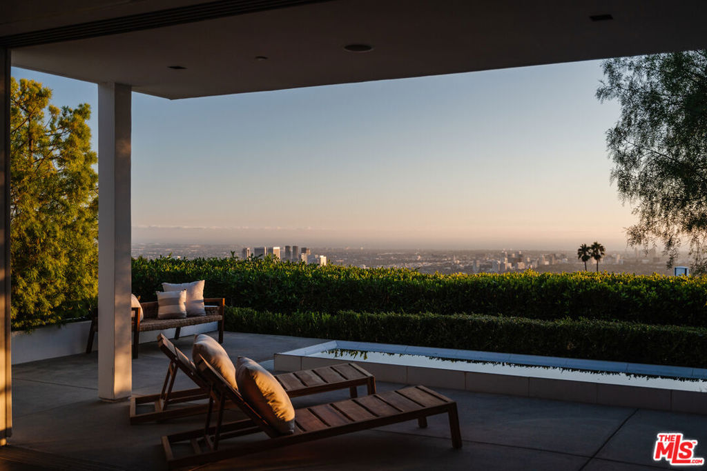 Situated in Trousdale, one of the most sought-after Beverly Hills enclaves, this discreet, gated, and stunning modern residence has been carefully designed to fully embrace the awe-inspiring views of Los Angeles and the Pacific Ocean. Placed along a quiet street in Trousdale, the property encompasses six bedrooms, all ensuite, and expansive rooms for a seamless indoor and outdoor lifestyle. The impressive automatic sliding glass doors are designed to merge the impeccable interior spaces with the infinity pool and the surrounding outdoors and gardens. A rare trifecta of incredible volume, magical natural light, and an abundance of wall space within the home makes it ideal for art collectors. While the design and craftsmanship notes of this home are too numerous to list, one must pay attention to the impeccably crafted gourmet kitchen, a private screening room, a TechnoGym fitness room, a temperature-controlled wine room, four-car garage, a large motor court and a primary suite that epitomizes luxurious California living with its own private terrace, reflecting pool, fireplace, and views that stretch from the city, ocean and beyond. This is truly an extraordinary opportunity to acquire one of the most notable modern homes in one of the most exclusive areas of Beverly Hills.
