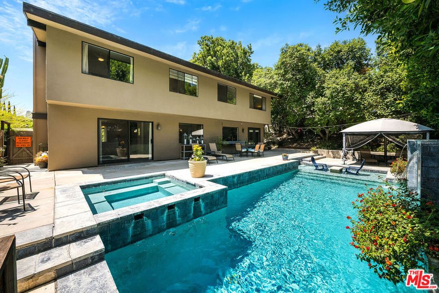 Unbelievable value in a 2 million dollar neighborhood! Tucked away west of Valley Circle, in one of Woodland Hills' most sought-after neighborhoods and adjacent to prestigious Hidden Hills, this beautifully updated two-story home combines modern comfort, space, and privacy.  With over 2,500 square feet of living space, this 5-bedroom, 2.5-bathroom home is thoughtfully designed for both everyday living and entertaining. The first floor features a formal living and dining room, a separate family room, a newly remodeled powder room, and an updated kitchen with a casual dining area. The kitchen showcases quartz countertops, shaker-style cabinetry with pull-out pantry shelves, stainless steel appliances, a 6-burner stove, and a built-in microwave.  Upstairs, you'll find five generously sized bedrooms, including a spacious primary suite with vaulted ceilings, a walk-in closet, and a private en-suite bathroom featuring a dual-sink vanity.  Step outside to your own private oasis. The resort-style backyard is framed by 30-foot privacy hedges and offers multiple areas for entertaining and gardening. At the heart of it all is a sparkling pool with a dramatic fountain and a separate spa, perfect for relaxing or hosting gatherings.  Situated on an expansive nearly 11,000 sq ft lot, the home boasts drought-tolerant landscaping with a drip irrigation system, a direct-access three-car garage, and a newer HVAC system.  Conveniently located near the 101 freeway, scenic hiking trails, and premier shopping and dining destinations such as The Calabasas Commons, Westfield Topanga, and The Village. Plus, it's within the boundaries of top-rated charter schoolsmaking this home the perfect blend of luxury, function, and location.