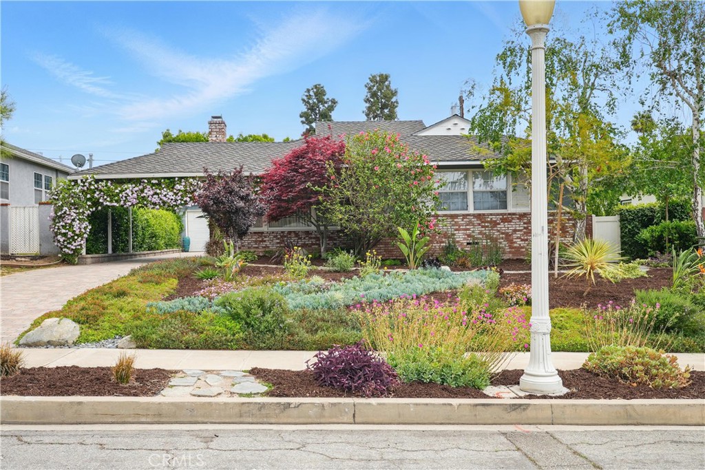 Tucked away on a quiet street in the desirable Burbank Hills, this inviting 3-bedroom, 2-bathroom home offers 1,722 square feet of comfortable living on a generous 6,945 square foot lot. Step inside to a bright and welcoming living room featuring hardwood floors, recessed lighting, and a cozy fireplace—perfect for relaxing or entertaining.
A formal dining room flows into the charming eat-in kitchen, which has been recently refreshed with newly painted cabinetry, tile countertops, and a spacious pantry. Just off the kitchen, a large and versatile family room provides even more living space for movie nights, a play area, or a home office.
The primary bedroom offers direct access to the backyard, while two additional bedrooms and two full bathrooms ensure comfort and functionality for family and guests alike.
Outside, enjoy a private backyard with a covered patio ideal for dining al fresco or lounging in the shade. A lush side yard is home to mature fruit trees including lemon, orange, mandarin, lime, pomegranate, and avocado—bringing charm and natural beauty to the space.
Modern upgrades include enhanced plumbing and electrical systems, new insulation, a newer roof and gutters, wired Ethernet throughout, leased solar panels, and drought-tolerant landscaping for efficiency and sustainability. The detached garage includes a workshop and a custom soundproof booth, perfect for creative projects or remote work.
Located in the highly rated Burbank Unified School District and close to parks, shops, and dining, this thoughtfully updated home blends classic character with added space and modern convenience in one of Burbank’s most cherished neighborhoods.