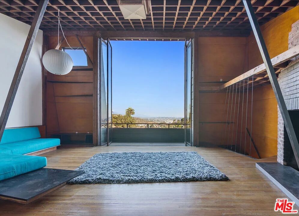 Tucked into the hills of Los Angeles, where architecture and landscape meet in perfect harmony, sits a home that is more than a residence it's a landmark. Welcome to 8663 Nash Drive, the very first architectural masterpiece by the legendary A. Quincy Jones, a name synonymous with postwar modernism, innovation, and timeless California design.Designed by Jones and his wife Ruth Schneider shortly after graduating from architecture school, the duplex-turned-personal-studio is as much a statement of vision as it is of form. Angled dramatically into the hillside, the structure maximizes western exposure and sunset views, creating dynamic, light-filled interiors defined by slanted walls, custom bookcases, and surprising spatial geometries. Jones would go on to become one of the most important architects of the 20th century collaborating with Paul R. Williams, shaping the Case Study House program, and pioneering modern residential subdivisions with Joseph Eichler. But it all began here.This is where vision took root. And today, it has been brought back to life in a way that is both reverent and revolutionary. This is the smaller of the two townhomes, both structures can be leased at $18,000/month