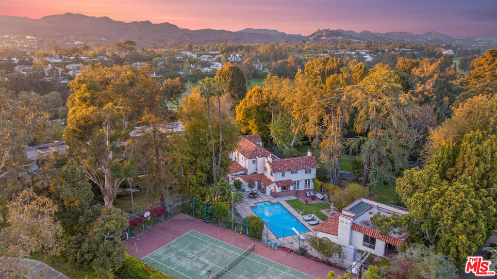 With a legacy that spans over a century, Woodacres Estate enjoys the distinction of being one of Santa Monica's most coveted residential opportunities to be brought to market. Surrounded by majestic pine trees and lush gardens, Woodacres Estate presents a peaceful sanctuary on 1.223 acres one of the largest flat parcels in the City of Santa Monica. A gated presence at the end of a private cul-de-sac north of San Vicente Boulevard places the historic property close to the Pacific Ocean, beaches and the restaurants and shops on Montana Avenue. Only two private owners have ever stewarded the property, which today consists of an original Italian Renaissance-style mansion designed by celebrated architect John Parkinson in 1921, a guest house with a two-car garage, a tennis court and a pool. Designed as Parkinson's personal home, the main residence offers more than 4,700 square feet with five bedrooms and 3.5 baths on two stories. The two-story guesthouse, built by the second owners in 1970, offers three bedrooms and two baths. The estate's next owner is invited to continue the legacy begun by Parkinson a century ago. Woodacres Estates presents a once-in-a-lifetime opportunity to recreate today's version of a Santa Monica estate compound with a new mansion and possible restoration of the main residence as a guesthouse.