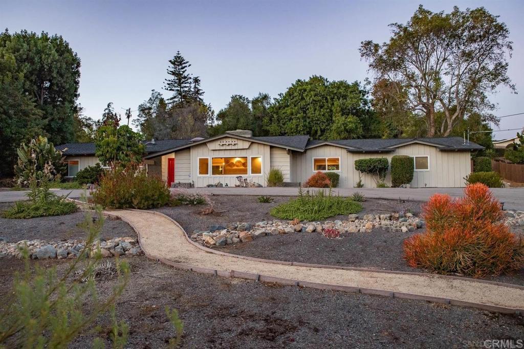 Welcome Home! This mid-century single-story Mt. Helix ranch style home is situated on a half-acre lot. Featuring vaulted ceilings with rich wood beams, a timeless fireplace, and skylights that fill the spacious living area with natural light. The large living room window boasts mountain views. Energy-efficient upgrades include PAID-OFF SOLAR panels, dual-pane windows, central A/C, two mini-splits, and an EV charger which enhance the appeal of this wonderful home. The outdoors feature a welcoming U-shaped driveway with room for up to 10 cars, plus dedicated RV and boat parking. This home is designed for convenience as well as curb appeal. The generous backyard retreat complete with new artificial turf, drought-tolerant landscaping, and low maintenance hardscape is perfect for entertaining, playing, or relaxing. Enjoy the ease of ranch-style living within walking distance to the coveted Fuerte Elementary school. This property offers a rare combination of character, practicality, and comfort.