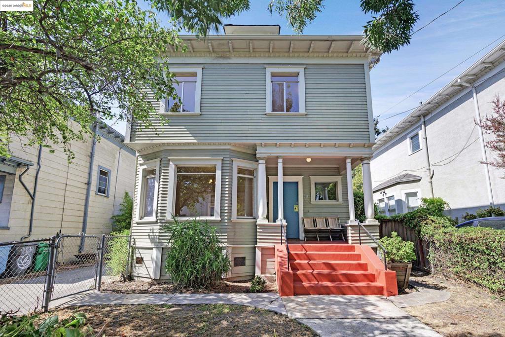 This stately 5 bed/2 bath American Craftsman stands tall and proud on a lush, tree-lined street ready for your vision. From the gracious entry with its built-in shelving, under-stair coat closet, and the handsome staircase, you step into a grand living room with light-filled bay windows, large enough for entertaining a crowd. The wood pocket doors provide historic elegance and flexible separation from the dining room, which has more period details: another bay window, a fireplace with an elegant carved mantelpiece, and glass-front built-in cabinets. Beautiful hardwood floors and picture rail molding are the finishing touch. A huge kitchen (will be stunning with your love), bathroom, laundry area, and a back bedroom (or home office) complete the first-level. Upstairs, four comfortable-sized bedrooms and a bathroom flank a central landing with a pull-down ladder to the attic. Here a surprise space awaits: an art studio, office, yoga room, play space… you decide. The fenced, level backyard has a patio for dining al fresco and an expanse for gardening, or even an ADU. This prime location is 1 block to Grove Park, 2.5 blocks to BART, close to Berkeley Bowl, restaurants, cafes, shops, and easy freeway access.