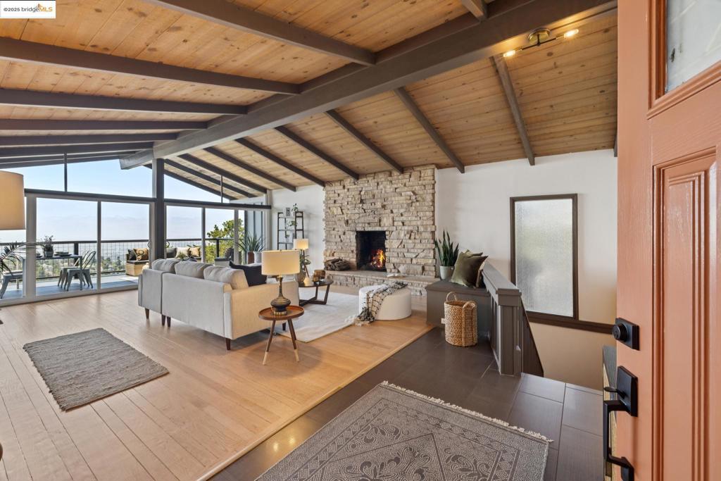 Sweeping Bay Views & Sophisticated Mid-Century Living in lower Piedmont Pines. Located just minutes from the Montclair Village, this spacious Piedmont Pines residence offers stunning, unobstructed views of San Francisco and the Bay—an exceptional backdrop for everyday living. Thoughtfully remodeled and seismically upgraded, the home combines timeless Mid-Century design with modern comforts. The level-in entry opens into a dramatic living room with soaring vaulted ceilings, a statement stone fireplace, and walls of glass that frame the panoramic views. Sliding doors connect to an expansive deck that stretches across to the dining area—ideal for entertaining or peaceful mornings above the trees. The kitchen, its breakfast nook, and a sleek half bath completes the main level. Downstairs, a generous family room with a brick fireplace anchors the private bedroom wing, which features four bedrooms, including a spacious primary suite with a beautifully renovated en-suite bath. A remodeled guest bath serves the secondary bedrooms. Bonus: a permitted studio apartment with a private entrance, bedroom, kitchenette and its own deck offers guests/family flexibility. Live like you're on vacation while enjoying easy access to Montclair’s beloved shops, restaurants, transit, and freeways. Views: Downtown
