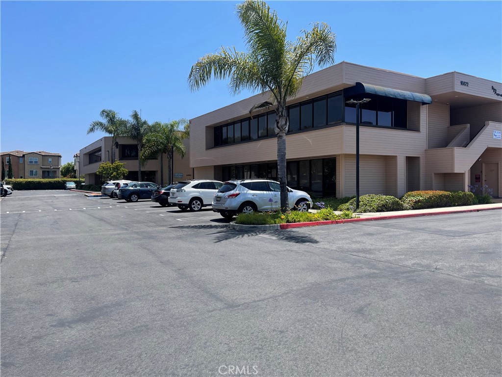 Prime first-floor commercial office space available for lease in a 2 story buliding, offering approximately 571 sq. ft. divided into 3 separate rooms. 1 large reception front office with 2 separate offices. This versatile layout is ideal for professional uses such as attorney office, real estate office, medical and much more. The property is conveniently located about 1.5 miles from the beach, providing easy access for clients and staff. Enjoy a professional setting in a sought-after area, perfect for businesses seeking a functional and welcoming office environment. There is ample parking for your clients. This unit is attached to another unit #110 and has 709 Sq Ft that could be combined if needed. See MLS # OC25125101