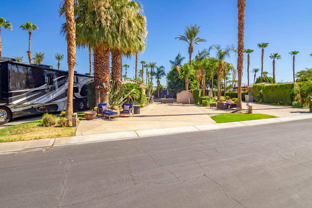 Welcome to Lot 14 at the prestigious Motorcoach Country Club in Indio, California--one of the top-rated Class A resorts in the country. This beautifully developed back-in privacy lot offers the perfect blend of resort-style amenities, thoughtful upgrades, and effortless outdoor living.The centerpiece of the lot is a custom-built pool and raised spa, complete with a soothing waterfall feature, natural rock accents, and stained cantilever coping. Enjoy quiet evenings around the propane fire table, cool off under the outdoor shower, or relax in the shade beneath the oversized umbrella.The remodeled casita is ideal for guests or extended stays, featuring a full-size refrigerator, dishwasher, microwave, double sink, updated shower and bathroom, and a mini split A/C unit for year-round comfort.An entertainer's dream, the outdoor kitchen includes a pro-grade gas BBQ, refrigerator, icemaker, sink, and ample stainless-steel storage, all topped with elegant flagstone countertops. High-end outdoor furnishings are included--so the lot is ready to enjoy on day one.In addition, the owner's 37' Newmar Baystar Coach and Electric Duffy Boat are also available for purchase, offering a unique opportunity to step into the MCC lifestyle fully outfitted and ready to go.Motorcoach Country Club is a private, guard-gated resort exclusively for Class A coaches 30' or longer. Residents enjoy three swimming pools, four pickleball courts, two tennis courts, a fitness center with saunas, and a championship 18-hole executive golf course. The recently renovated on-site restaurant and full-service bar sit alongside scenic waterways and beautifully landscaped grounds, creating a true luxury resort experience.Whether you're looking for a relaxing desert getaway, a high-end rental investment, or a full-time RV lifestyle, Lot 14 delivers privacy, quality, and value. Motorcoach Country Club exclusively accommodates Class A motorhomes from 30' to 45'. Due to zoning, on-site properties are not considered dwellings, and overnight stays inside them are not allowed. MCC's annual Food & Beverage minimum is $2,080.