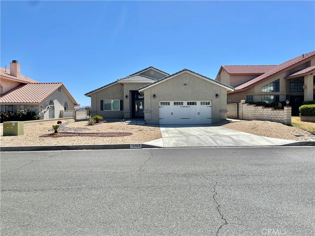 Welcome to SINGLE-STORY HOUSE 13165 Palos Grande Dr Victorville located in the well-known SPRING VALLEY LAKE community with 5 BEDROOMS, 3 BATHROOMS, YEAR BUILT 2019. This Stunning Home greeted by an OPEN FLOOR PLAN of family room, dining room, and the kitchen. In the living room you will find a gorgeous STACKED STONE FIREPLACE. The KITCHEN has QUARTZ/Calacatta Stone COUNTERTOPS, Ample Storage, Wine Rack, and Stainless Steel Appliances. There is a junior suite in the 5th BEDROOM WITH ITS OWN BATHROOM and WALK-IN CLOSET. The MAIN BEDROOM has a nice en SUITE with DUAL SINKS and VANITY, Spacious WALK-IN CLOSET, huge SLIDING DOOR, and VIEWS that never end. All 5 bedrooms has DUAL PANE WINDOWS with SHUTTER WINDOW BLINDS. This home is situated in the ideal location, close to Jess Ranch Marketplace, the Mall, businesses, shopping centers, and more! Spring Valley Lake offers a huge 200 acre lake with beach front access perfect for swimming, boating, fishing, 18 hole golf course, gym, playground, tennis courts, restaurants, walking, biking trails the list goes on for its lake and family-friendly neighborhood.
Make This Turnkey Home for You and Your Family now!