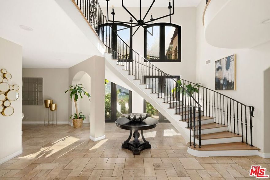 Located in the prestigious guard gated community of Hidden Hills, this beautifully updated 5-bedroom, 6-bathroom estate sits on a large private lot surrounded by mature trees, lush landscaping, and serene park-like grounds. The property features a sparkling pool and spa, a two-stall barn with turnout and trail access, and plenty of space for outdoor living and entertaining. Inside, the home offers high ceilings, hardwood and limestone floors, and expansive living spaces filled with natural light. The custom chef's kitchen includes a bright breakfast area that opens to an outdoor dining patio, ideal for seamless indoor-outdoor living. Each of the five en-suite bedrooms is spacious and private, including an upstairs primary suite with a sitting area, dual walk-in closets, a luxurious bathroom, and a private gym or yoga and meditation room. Additional features include a formal dining room, a large game room, a family room with a built-in bar, and a private office. This home offers the perfect blend of timeless elegance, comfort, and the relaxed California lifestyle in one of the most sought-after communities.