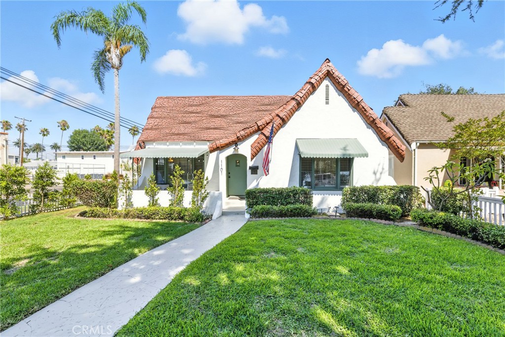 Welcome to this beautifully preserved historic home located at 1101 S Birch Street in the coveted Wilshire Square neighborhood of Santa Ana. This charming 3-bedroom, 2-bathroom property blends timeless architecture with modern updates, offering the perfect mix of comfort and character. As you approach the home, you'll be greeted by its classic Tudor Revival-style exterior, featuring a unique roof design and a well-maintained front yard with lush greenery. The inviting curb appeal sets the tone for what lies inside. Step into the bright and airy living room, where large windows allow natural light to flood the space. The cozy living area features a charming fireplace with beautiful vintage tilework, adding a touch of warmth and character. The alcove above the fireplace is perfect for showcasing decorative pieces, while the surrounding shelves provide space for personal touches and art. The kitchen is both functional and filled with charm, maintaining the home’s timeless feel while providing all the essentials. Each bedroom is spacious, with original architectural details that add to the character of the home, while offering comfort and convenience. Bonus room that is perfect for an office is right off the dining room. Sitting on a large lot of over 7,200 sqft. Located in the historic Wilshire Square neighborhood, this home truly embodies the rich history of Santa Ana, with its classic charm, thoughtful updates, and beautiful outdoor space. Don’t miss your chance to own a piece of Santa Ana history! Call to schedule your private tour, today!