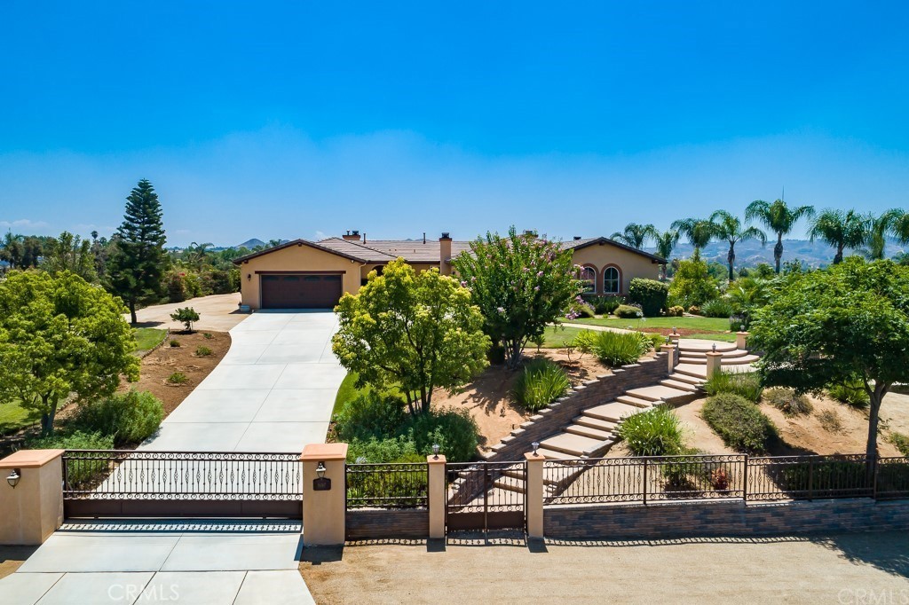 Welcome to 16767 Eagle Peak Road, Riverside, CA – Where Elegance Meets Equestrian Living
Tucked away in the prestigious Bridle Creek community of Riverside, this beautifully appointed single-story estate is the epitome of Southern California living. The front yard has professionally designed hardscaping with a stacked-stone accents, decorative concrete, and professional lighting through out. Enjoy evening nights in a cozy front courtyard with fireplace. Out back, enjoy a covered patio, horse-zoned grounds, and endless potential on a flat 1-acre lot. All this tucked within an equestrian community with scenic trails and top-rated schools. A chef-inspired kitchen with granite-topped island, double ovens, breakfast bar, walk-in pantry, and custom cabinetry. Casual family room is open to kitchen. Fireplaces in multiple spaces. Primary suite offers a spa-like retreat, while an additional en-suite bedroom adds flexibility for guests or multi-gen living with combined 4 bedroom plus an additional office. A true 4 car garage offers parking for cars and storage. Solar panels are paid off! All this set with in a quiet community.