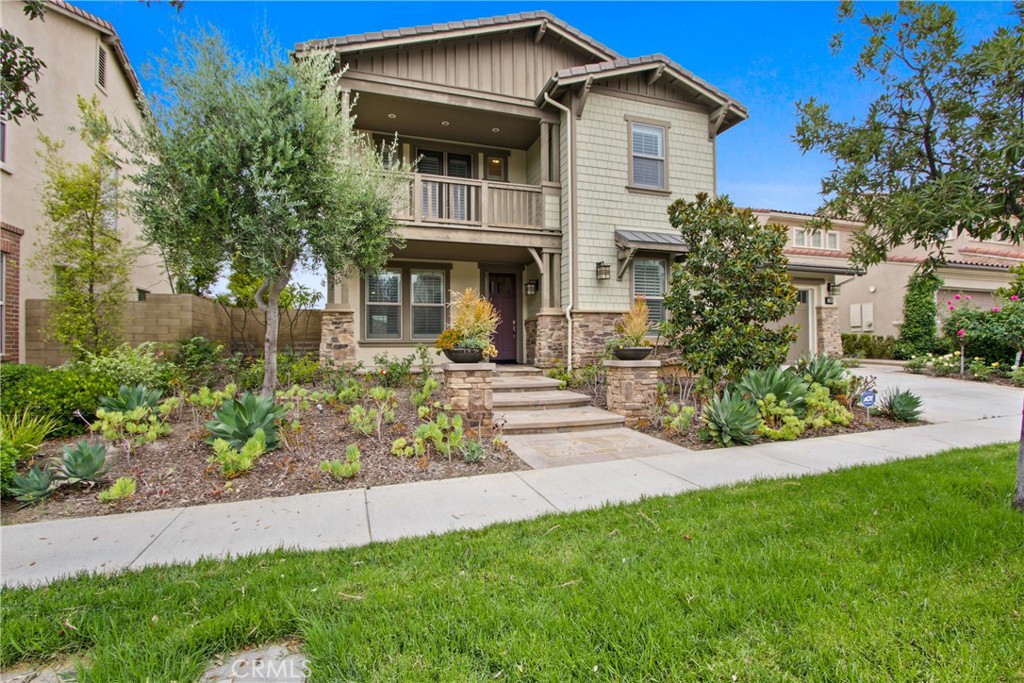 Welcome to this spacious 4 bedroom + den, 4.5 bathroom home located in the desirable Pavilion Park community by Shea Homes. Designed with comfort and functionality in mind, the open-concept layout connects the living, dining, and kitchen areas—ideal for both everyday living and entertaining. The kitchen features stainless steel KitchenAid appliances including a built-in oven, microwave, six-burner cooktop, refrigerator, and dishwasher. A large center island offers generous workspace and storage. The original walk-in pantry has been thoughtfully reimagined as a built-in wine display area, adding a unique touch to the kitchen. The home includes a convenient first-floor bedroom suite, while each of the upstairs bedrooms enjoys its own private bathroom. The primary suite features dual vanities, a soaking tub, a walk-in shower, and a large walk-in closet. One secondary bedroom also offers access to a private balcony. Through oversized sliding doors, the backyard provides a welcoming space for outdoor dining or relaxation, complete with a built-in fireplace. The den offers flexible use as a home office, study, or playroom. Residents enjoy access to a wide range of Pavilion Park amenities, including pools, parks, clubhouse, BBQ and picnic areas, sports courts, and scenic walking trails. Located within the award-winning Irvine Unified School District and just minutes from shopping, dining, healthcare, and major freeways.