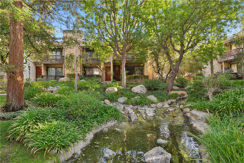 Welcome to Warner Village, where your dream tri-level townhouse awaits! This charming end unit boasts three spacious bedrooms and two and a half bathrooms, perfectly designed within an open floor plan that spans 2,022 square feet. Located in a tranquil location, you’ll enjoy picturesque views of serene streams, and refreshing pools with running water right next to the front door. Step inside to discover a bright living room featuring high ceilings and a cozy fireplace. The kitchen is a chef's delight with elegant granite counters, a delightful balcony, and a convenient eating area. Entertain guests in the formal dining room that leaves a lasting impression. The upstairs bedrooms are generously sized, with the primary bedroom offering a luxurious walk-in closet and its own private balcony. Plus, a versatile utility room provides the perfect space for an office or guest room. The HOA includes water earthquake insurance cable and the internet. The B tax rolls indicate 1,631 square feet, however the builder floor plan was measured as 2022 Sq Ft including the bonus room. Buyer to verify the square footage. One year old air conditioner. New electrical panel. Enjoy the shopping,restaurants,parks and easy access to nearby freeways and beaches.