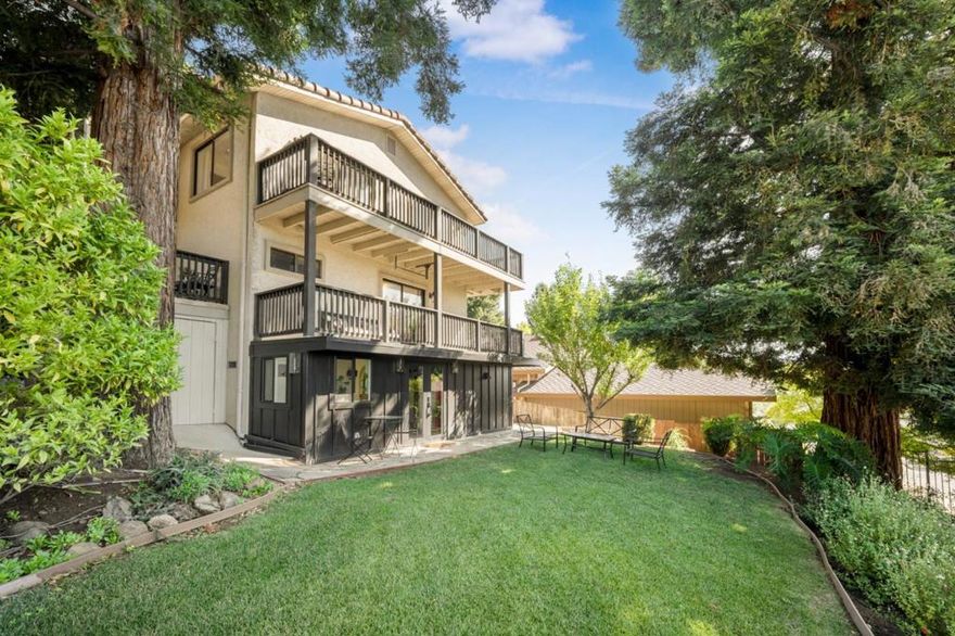 Custom Home w/Views! Welcome to 17750 Trumpp Court, a sophisticated residence gracefully set on a gently elevated corner lot on the West Side of Morgan Hill. This distinctive setting offers scenic views from most windows and spectacular city light vistas from the upper-level east-facing windows, creating serene moments of beauty throughout the day and into the evening. Framed by four majestic redwoods, the home feels like a secluded retreat, blending privacy with natural charm. Built with high-grade lumber and copper piping throughout, it reflects quality craftsmanship inside and out. The main living area offers 1,808 square feet of thoughtfully designed space, featuring three spacious bedrooms and 2.5 tastefully appointed bathrooms. Beyond the primary living space, the custom-built home includes a finished attic, ideal as a playroom or for extra storage, and a converted basement that provides flexible bonus space to suit a variety of needs. A two-level wrap-around porch invites relaxed outdoor living and entertaining, while the interior is adorned with a stunning chefs kitchen, perfect for hosting and everyday enjoyment. The professionally landscaped yard features a variety of fruit trees, a basketball court for recreation, and plenty of room to unwind. Set on a 7,720 sf. lot.