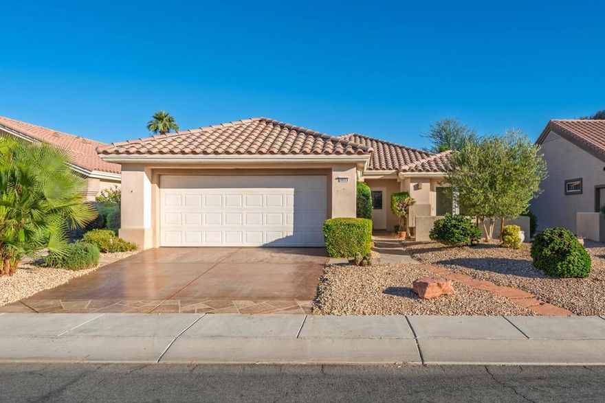 Sun City Palm Desert - Gorham. Ideally located just a short distance from both the Mountain View and Sunset View Clubhouses, this charming home offers comfort, style, and convenience. The north-facing rear yard features a spacious covered patio surrounded by lush desert landscaping--perfect for outdoor relaxation. Curb appeal abounds with a decorative concrete driveway, front courtyard, and coordinated hardscape. Inside, diagonally laid tile flooring extends throughout the main living areas, with shutters on most windows. The kitchen and dining area feature vaulted ceilings, adding to the home's open and airy feel. The kitchen includes Corian countertops, a breakfast bar, and a skylight for natural light. The dining area has a bay window and a slider leading to the rear patio. The primary suite includes two closets with mirrored wardrobe doors, a vaulted ceiling, and direct access to the covered patio. Its en suite bathroom offers dual sinks, a stall shower, and a Solatube for added light. The guest bedroom has its own slider to the front courtyard and is adjacent to a full bath with a tub/shower combination. Additional features include an interior laundry room and a two-car garage with its own air conditioning and abundant storage space. The home's main HVAC system was replaced in 2019.
