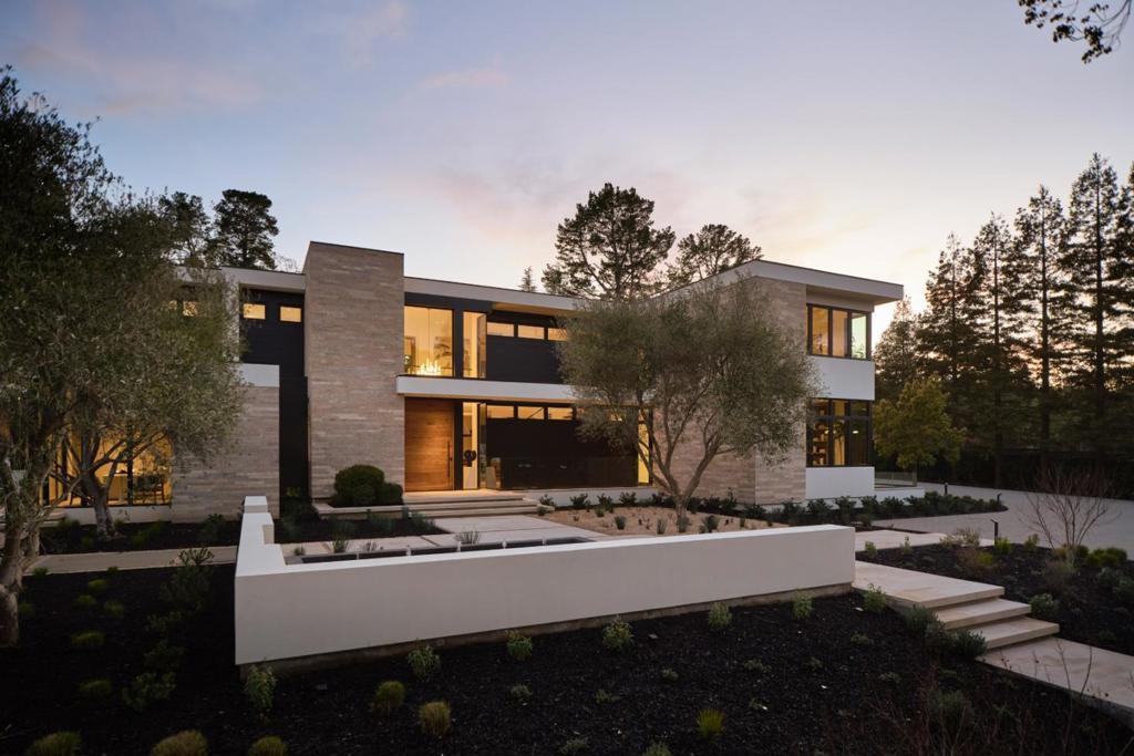 Flawlessly finished, this new contemporary masterpiece makes a commanding first impression at the end of a cul-de-sac on one fully landscaped acre. The interiors are introduced by a solid walnut pivoting front door and floating staircase to one side that culminates with a sculptural piece of carved Wenge wood. Disappearing walls of glass open the formal venues to the sights and sounds of the rear grounds where a shimmering pool is set before a series of fountains and vast terraces invite outdoor living. Modern ingenuity is a hallmark of the finishes, lighting, system controls, and the entire homes carefully planned layout. Two full kitchens allow private space for a personal chef, a front multi-room suite is designed as an ADU or office. Recreation space, a theatre, fitness center and wine cellar along with 6 spacious bedrooms plus a guest house round out this remarkable home. This eco-friendly home has an elevator, solar power, synthetic lawn, and EV charging for two.