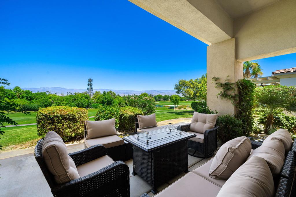 Fabulous elevated views! GOLF Membership Available - No wait! This Bougainvillea 1 model has expansive views of the mountains and Grove #12 with the lake and Grove #11 beyond. This popular model home has an open floor plan - all living/dining areas open out to the patio and those great views! Patio features a built-in BBQ with several areas for entertaining/dining. Offered furnished per inventory and upgraded throughout! Some of the updates include: Owned Solar, New A/C + heat pump, tankless water heater, stainless appliances (including double ovens, microwave & wine refrig), new LED & lighting...and more! Living room area has a fireplace and wet bar. Kitchen features stainless appliances and a bar with counter seating. Dining area opens out to the patio BBQ area. The Primary Suite has its own private access to the fairway patio - walk in closet, tub and separate shower in the ensuite bathroom. The two Guest bedrooms are ensuite. Attached 2-car garage + golf cart garage. Community pool/spa is across the street, just a few doors away. Close to the clubhouse, this home is just a cart ride to the sports club, dining & tennis/ pickleball. This home is located in the HOA - the HOA monthly dues include security, cable & internet, all gardening, exterior paint, roof maintenance, exterior water, exterior pest control and trash. Indian Ridge CC features two Arnold Palmer Signature golf courses, tennis/ pickleball facilities, a fitness center, a full-service spa, two restaurants, 38 community pools/spas & active social calendar. Come and join the fun!