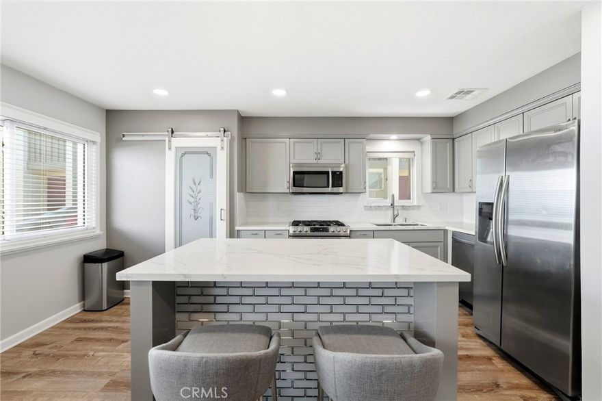 Turnkey 3+2.5 townhome with private 2-car garage! Bright & airy, step into a spacious living room with tall windows and lots of light. The updated kitchen features a barn-door pantry, quartz counter tops and and central island for easy entertaining. Full-size side-by-side laundry on top floor. Private 2 car garage with epoxy floors and lots of storage. Central AC & Heat. The AC condenser, dishwasher, and electrical panel have all been replaced in the last few years. Enjoy your summer nights on the private gated patio area with built-in gas grill. HOA amenities include a pool, a spa, rec room, EQ insurance and internet & cable TV! Convenient location near Metrolink, freeway, Warner Center, Topanga Mall,  The Village, Porter Ranch, and some of the best hiking and climbing in the LA area.