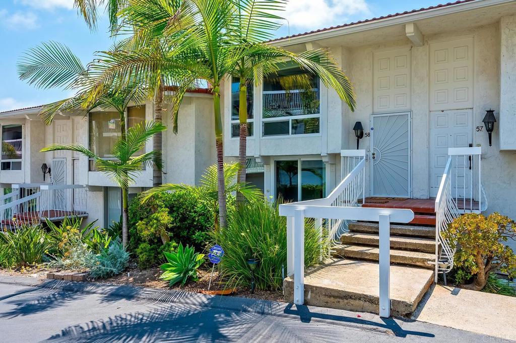 Enjoy tranquil Batiquitos Lagoon and ocean views from this well-appointed 2-bedroom, 2.5-bath home. The entry and staircase feature elegant porcelain tile, leading to a light-filled open-concept living area enhanced by floor-to-ceiling windows. The kitchen showcases warm maple cabinetry, granite countertops, Tuscan-style tile accents, and brushed stainless steel appliances—offering both style and functionality. Step out onto the balcony, relax, unwind and take in colorful sunset skies. A rare half bath on the main level adds convenience for guests. Downstairs, the spacious primary suite includes a private balcony, soaking tub, updated vanity, and a generous walk-in closet. The second bedroom offers ample space and direct access to a private patio—perfect for guests or a home office. The lower level features a two-car garage and a dedicated laundry area all with direct entry to the home. Set in a desirable coastal neighborhood, this home blends relaxed coastal living with thoughtful design. A must-see!