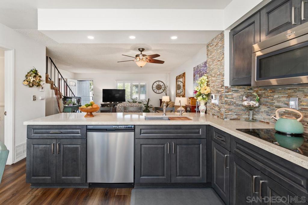 Welcome to this charming 2-story, 2-bedroom/1.5-bath townhome retreat near serene Lake Murray. This beautifully updated property offers a recently renovated kitchen, complete with exquisite, oversized quartz countertops and modern appliances, creating a paradise for cooking enthusiasts. The spacious layout boasts smooth textured ceilings and recently upgraded flooring throughout the downstairs, seamlessly connecting the living, dining, and kitchen areas, which lead out to the spacious private... courtyard (approx. 15' x 18') providing an ideal space for entertaining guests or simply relaxing in style. As you ascend the staircase, you’ll find newer carpeting and well-appointed bedrooms which a offer a peaceful sanctuary for rest and relaxation. The primary bedroom offers a private balcony where you can savor your morning coffee while enjoying a gentle breeze and picturesque surroundings, as well as views of Mount Helix in the distance. The community amenities include a pool and spa, tennis court, basketball and pickleball, and two separate playgrounds for the kids, and offer additional opportunities for recreation and leisure. Conveniently located near Lake Murray, residents can easily indulge in outdoor activities such as hiking, biking, and tennis or simply taking a leisurely stroll along the tranquil shores. With its prime location, this townhouse offers effortless access to shopping, dining, and entertainment with Grossmont Center located nearby, as well as close proximity to groceries and most of life’s other necessities. Additional features include: soft-closing cabinets & drawers in the kitchen; ceiling fans in the living room and both bedrooms; dual paned windows throughout; plantation shutters; stacked stone backsplash; stainless steel finish appliances; spa bathtub; new water heater; additional storage under the stairs; upgraded upstairs bath with travertine style tile floor and shower.