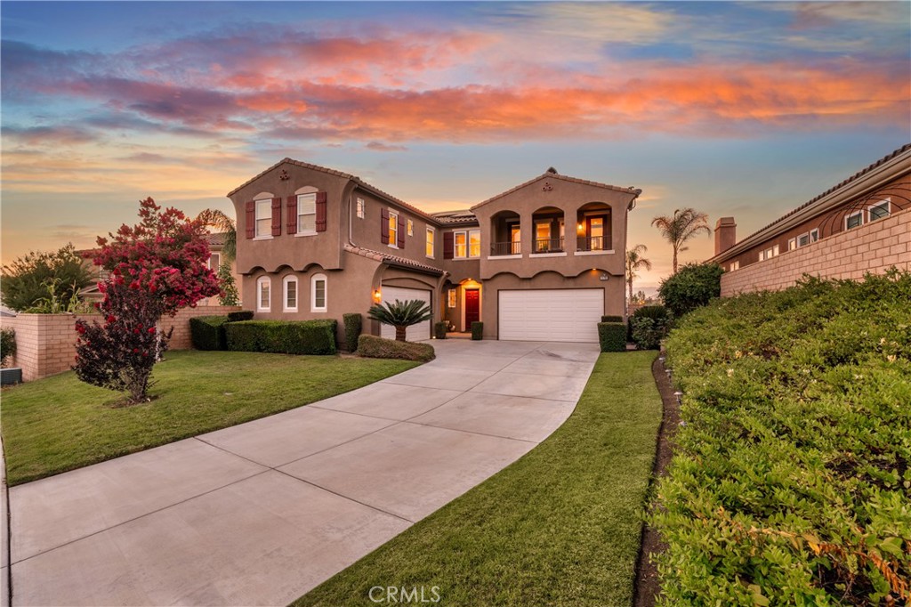 Perched on a quiet cul-de-sac in Lake Hills Reserve, this spacious, 4850 SqFt Executive Home offers the perfect blend of functionality, elegance, and energy efficiency complete with a whole house fan and FULLY OWNED SOLAR!! From the moment you step inside, you’re greeted by soaring ceilings, an open entryway, and warm laminate wood flooring that leads to the formal living and dining areas. Thoughtfully designed for multigenerational living, the downstairs Jr. Suite features its own private bathroom -- ideal for guests or long-term stays. The kitchen features granite countertops, stainless steel everything including single basin sink, double ovens, a built-in microwave, vent hood, and a large island crowned with designer pendant lighting. A walk-in pantry and abundant cabinetry provide ample storage, while porcelain tile underfoot adds a sleek, durable finish. Upstairs, luxury vinyl plank flooring flows throughout. The primary suite offers a true retreat with a cozy fireplace sitting area, two walk-in closets, and two private balconies each with breathtaking panoramic views of the surrounding hills and views of the city skyline from the rear balcony! The en suite bath includes a jetted tub, walk-in shower, dual vanities, and a dedicated makeup area. Additional features include a spacious upstairs bonus room, generously sized secondary bedrooms including an additional Jr. Suite, designer lighting, ceiling fans, and a whole-house fan for year-round comfort. Out back, enjoy low-maintenance living with artificial turf, upgraded hardscape, and plenty of room to entertain. A long driveway leads to two separate garages with space for four vehicles -- perfect for car enthusiasts or large households. Situated on 750 acres, Lake Hills Reserve offers its residents an ideal mountaintop locale removed from city life, yet close to the many cultural and educational amenities of Riverside County and shopping. Residents enjoy the expansive open space, the HIGHLY rated Lake Hills Elementary and a private residents club including a swimming pool, playground, park and an open-air fireplace pavilion. This is an ideal location for commuters as the 91 Freeway and Metrolink are both close by. Are you ready for the Lake Hills Reserve lifestyle?