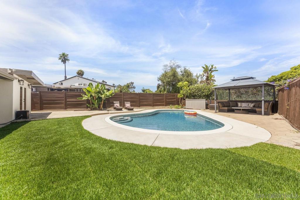 A Turnkey Clairemont Gem with Pool, Bonus Living Space, and Owner Solar with a Backup Battery! Tucked away on a private, family-friendly court with no-through traffic, this beautifully renovated 3-bedroom, 2-bath, 1,050 sq. ft. home (plus 240 sq. ft. of additional livable space) offers the perfect blend of style, function, and comfort. The flexible bonus space is ideal as a home office, playroom, or creative studio, giving you room to customize the home to your lifestyle. The 8-foot deep pool calls for Sunny San Diego Pool Parties! Set on a spacious 6,900 sq. ft. lot, the property’s oversized backyard feels like your own private retreat, complete with a sparkling pool, covered patio, grassy area, and multiple spaces to relax or entertain. Inside, you’ll love the brand-new kitchen with modern Slim Shaker cabinets, quartz countertops, stainless steel appliances and a walk-in pantry. Fresh interior and exterior paint, brand new dual pane windows, Luxury Vinyl Plank flooring, and large sliding doors fill the home with natural light and create a seamless indoor-outdoor flow. This energy-efficient home also comes with owned solar panels and a backup battery, ensuring low utility costs and peace of mind. With its prime location on a quiet court, modern upgrades, and a resort-style backyard, this Clairemont charmer is perfect for families or anyone seeking their own private retreat just minutes from shopping, dining, parks, and the beach.