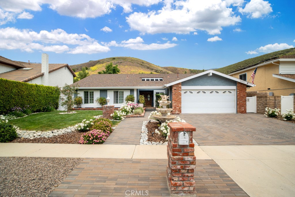Executive Single-Story Home in Chaparral Estates, Oak Park
Nestled in the prestigious Chaparral Estates area of Oak Park, Ventura County, this beautifully expanded custom single-story residence offers the perfect blend of elegance, comfort, and privacy. On the market for the first time in decades, this meticulously maintained home is a rare gem.
From the moment you arrive, the professionally landscaped grounds with lush greenery, a serene fountain, and a custom brick paver driveway set a welcoming tone. Double entry doors open to an airy, open-concept floorplan featuring sophisticated travertine floors and abundant natural light.
The formal living room exudes warmth with its rich wood flooring, beamed ceiling, and a striking custom fireplace. Just adjacent, the formal dining area boasts travertine marble floors, crown molding, and recessed lighting, creating a refined space for entertaining.
The heart of the home is the custom cook’s kitchen, designed for both function and style. It features stainless steel appliances, and granite countertops, seamlessly flowing into a casual dining or bonus area and a spacious family room. The family room offers vaulted beamed ceilings, a bay window, a ceiling fan, and a second beautiful fireplace — perfect for cozy gatherings.
The guest bathroom, conveniently located off the family room, includes a shower. The luxurious primary suite is a true retreat with wood-like floors, recessed lighting, a ceiling fan, a walk-in closet, an additional mirrored wardrobe, and a generous sitting area with direct access to the backyard. The ensuite bathroom features a vanity and stall shower.
Three additional bedrooms also feature wood-like flooring, recessed lighting, and mirrored wardrobe closets, sharing a well-appointed full bathroom with a tub and shower.
Step outside to your private oasis — a sprawling, flat backyard with fountains, a covered patio, and a large separate gazebo perfect for entertaining. Fully fenced and offering total privacy, this outdoor space is designed for relaxation and celebration alike.
Additional highlights include solar power and timeless architectural details throughout. This exceptional home truly has it all — space, style, and location. Don't miss this rare opportunity to own in one of Oak Park’s most sought-after neighborhoods.
