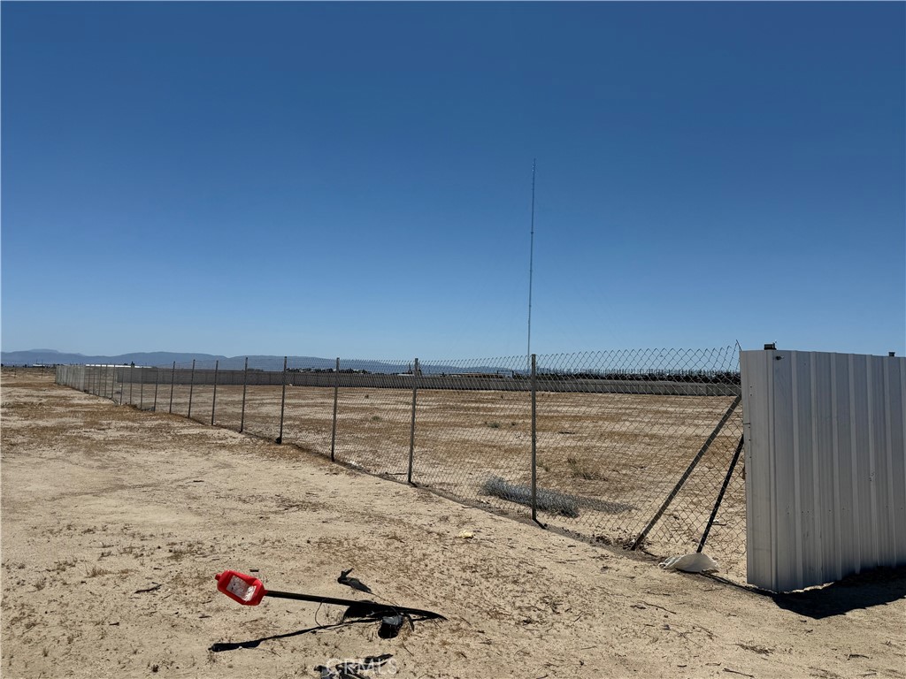 Rare Industrial Opportunity in Rosamond, CA - 5± Acres Unlock a world of potential with this exceptional 5± acre parcel located in the heart of Rosamond's heavy industrial zone. This fully fenced property offers prime positioning and versatility for a range of industrial uses. A possible modular office/home structure is situated on-site and may be included in the sale—perfect for operational or administrative use (buyer to verify). Utilities are available on 15th Street (buyer to confirm with Kern County Planning Department). Conveniently located near El Tapatío, a well-established auto wrecking and heavy industrial business, this property offers excellent proximity to existing industry. Whether you're an investor, entrepreneur, or visionary, this property is your chance to secure a valuable piece of industrial real estate in one of Kern County's growing industrial hubs. Key Highlights: • 5± Acres in Rosamond's heavy industrial zone • Fully fenced for security • Potential modular office/home included • Utilities nearby (verify with Kern County) • Near established industrial businesses • Endless development potential Buyer to conduct all due diligence and verify zoning, usage, and permits with the appropriate authorities.