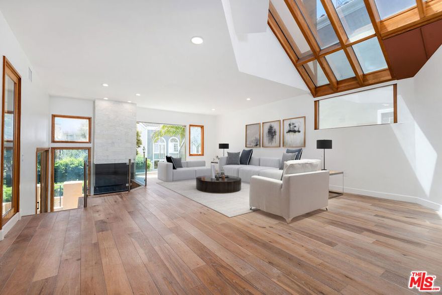 Experience the pinnacle of modern coastal living in this light-filled contemporary masterpiece, thoughtfully designed for comfort, style, and effortless indoor outdoor living. Just steps from the pedestrian bridge to the sand, this Silverstrand residence offers rare amenities, refined finishes, and a floor plan that adapts beautifully to your lifestyle. The ground level features a flexible media room complete with a built-in projector, en-suite bathroom, and generous storage, making it ideal as a private guest suite, office, or home gym. From here, you'll find direct access to the private courtyard as well as the rare four car garage, providing exceptional parking, storage, and convenience for coastal living. The main level showcases an elegant chef's kitchen appointed with Sub-Zero and Miele appliances, a dedicated wine fridge, and sleek, wide plank hardwood flooring. The open concept layout flows seamlessly into the dining area and bright living room, where soaring vaulted ceilings, an expansive skylight, and a cozy fireplace create a dramatic yet inviting atmosphere. Sliding glass doors open to an inviting sunny balcony, allowing ocean breezes and natural light to fill the space. The third level is home to the luxurious primary suite, featuring vaulted ceilings, dual walk-in closets, a private balcony, and its own fireplace. The primary en-suite includes a spa inspired bathroom complete with a large walk in steam shower, offering a true wellness experience. Two additional guest bedrooms are located across the hall, including one guest bedroom with its own balcony and a shared full bathroom with a steam shower. Crowning the home is a spectacular rooftop deck designed as a private retreat. Complete with a hot tub, sauna, outdoor shower, and sweeping coastal views, it provides the ultimate indoor outdoor sanctuary for sunbathing, stargazing, and evening sunsets. Additional highlights include a built-in dumbwaiter for easy transport of groceries and supplies between floors and ample guest parking, an uncommon luxury in The Silverstrand. Set within a secure enclave offering 24/7 private patrol, this exceptional beachside home is just moments from local restaurants, boutiques, and marina amenities. A rare blend of sophistication, comfort, and coastal lifestyle, this residence embodies the very best of Silverstrand living.