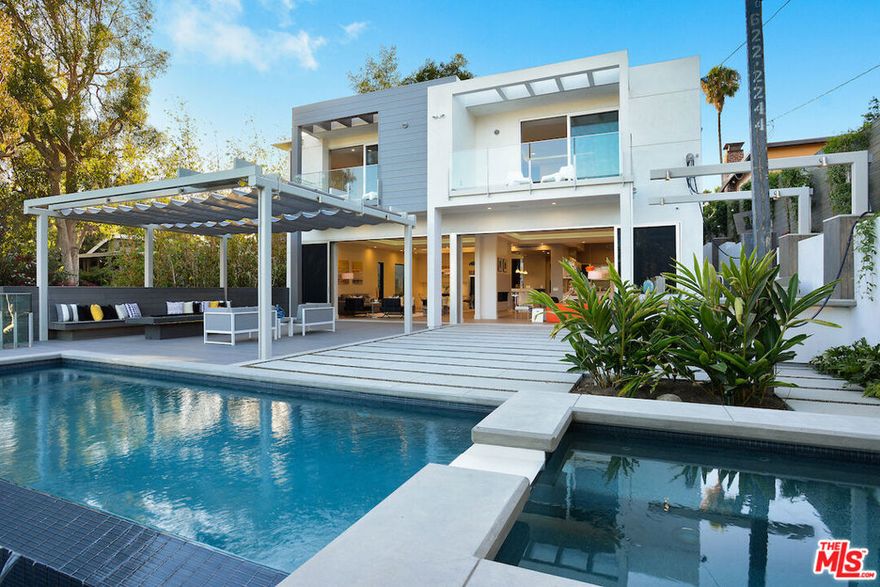 Step into a modern Pacific Palisades retreat. A sophisticated architectural showpiece thoughtfully crafted for contemporary California living. This immaculate five-bedroom, five and a half-bath residence delivers 4,752 square feet of bright, open living space and tall ceilings across multiple levels, set on an intimate, private lot. Entertain with ease in the chef's kitchen featuring generous prep space and seamless flow to formal and casual living areas, or host al fresco gatherings in beautifully landscaped outdoor garden and multiple terraces. Large principal suite offers a spa-like bath and generous closet space; additional en-suite bedrooms provide privacy and comfort for family and guests. Details and amenities include central air conditioning, in-unit laundry, multiple fireplaces, and a two-car attached garage. High-end finishes, thoughtful built-ins, and excellent natural light frame everyday living with an elevated, relaxed aesthetic. Located in one of Pacific Palisades' most desirable neighborhoods, this home provides proximity to local dining, beaches, and top schools while offering a private residential experience.