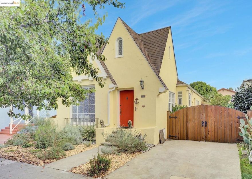 Step into storybook charm in this 1929 Tudor bursting with character and modern upgrades. Behind its cheerful stucco exterior and arched entry lies a warm, light-filled home with refinished hardwood floors, a cozy living room with vaulted beamed ceiling, and a sunny dining area that flows into an updated eat-in kitchen. The kitchen features stainless appliances, and a charming breakfast nook perfect for morning coffee. Two comfortable bedrooms and a refreshed bath create a thoughtful layout all on one level. Energy-saving owned solar panels and forced-air heat add comfort and efficiency. Outside, enjoy a fenced backyard ideal for entertaining, gardening, or relaxing under the California sun. The detached garage and off-street parking provide convenience and extra storage. Located just minutes from BART, shopping, and freeway access, this enchanting Tudor blends vintage character with modern livability in the heart of Oakland.