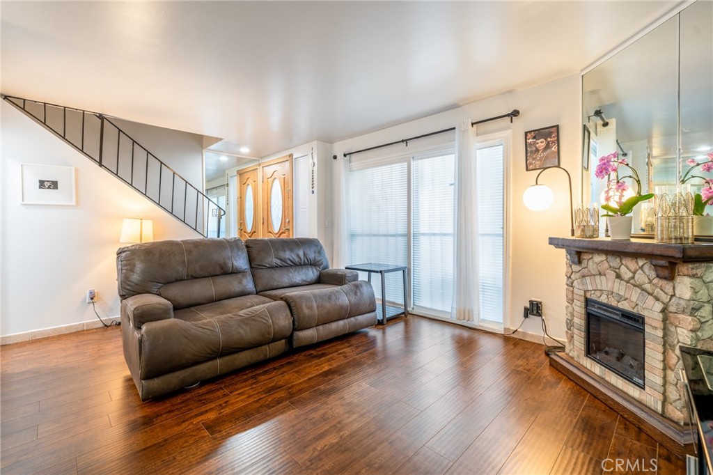 Welcome to this beautifully maintained 2-story townhome-style residence located in the desirable Northridge area. This home features an upgraded kitchen with modern appliances, ample cabinet space, granite countertops and direct access to a spacious 2-car garage with generous storage and in-unit washer/dryer. The open-concept dining area flows into a versatile bonus space ideal for a home office, study, or additional living area. The spacious living room features a cozy fireplace and sliding glass doors that opens to a private patio with a mature citrus tree, perfect for relaxing or entertaining. A convenient guest powder room is also located on the main level. Upstairs, you'll find two generously sized bedrooms connected by a well-appointed dual-access bathrooms. The primary bedroom includes two walk-in closets, offering abundant storage. Flooring throughout the home includes a mix of tile and wood blending durability with a warm aesthetic. Solar panels included providing energy efficiency and potential utility savings.