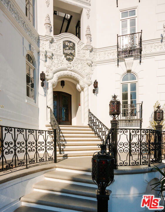 After nearly a century standing proudly in the heart of West Hollywood, the breathtaking El Mirador Apartments reopens its doors. Reborn, refined, and ready to welcome a new generation of residents. Following more than a decade of meticulous and sensitive restoration, this architectural jewel is a prime example of Churrigueresque Spanish Colonial Revival design and has been returned to its original splendor. Built in 1929 by renowned theater architect S. Charles Lee, it stands as a remarkable tribute to its era. Original floorboards were carefully lifted, revarnished, and placed back with reverence. Decades of paint and primer were patiently removed from hand-carved archways to reveal the craftsmanship beneath. Custom-imported rugs now line the grand corridors. Every salvageable element of the building's storied past has been preserved, fought for in some cases, with an unrelenting commitment to authenticity. In El Mirador, the devil is not just in the details. It is in the devotion. Inside each residence, modern comforts blend seamlessly with historic charm. Kitchens feature state-of-the-art appliances set in sleek marble surrounds. Discreet cabinetry conceals in-unit washers and dryers, while retractable screens disappear into window casings to preserve uninterrupted views. Modern comforts seamlessly blend with historic charm.