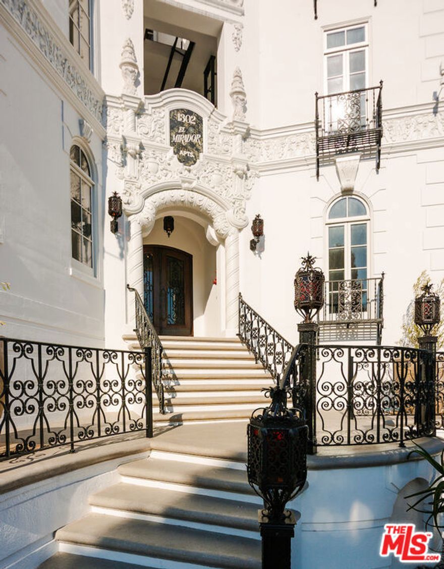 After nearly a century standing proudly in the heart of West Hollywood, the breathtaking El Mirador Apartments reopens its doors. Reborn, refined, and ready to welcome a new generation of residents. Following more than a decade of meticulous and sensitive restoration, this architectural jewel is a prime example of Churrigueresque Spanish Colonial Revival design and has been returned to its original splendor. Built in 1929 by renowned theater architect S. Charles Lee, it stands as a remarkable tribute to its era. Original floorboards were carefully lifted, revarnished, and placed back with reverence. Decades of paint and primer were patiently removed from hand-carved archways to reveal the craftsmanship beneath. Custom-imported rugs now line the grand corridors. Every salvageable element of the building's storied past has been preserved, fought for in some cases, with an unrelenting commitment to authenticity. In El Mirador, the devil is not just in the details. It is in the devotion. Inside each residence, modern comforts blend seamlessly with historic charm. Kitchens feature state-of-the-art appliances set in sleek marble surrounds. Discreet cabinetry conceals in-unit washers and dryers, while retractable screens disappear into window casings to preserve uninterrupted views. Modern comforts seamlessly blend with historic charm.