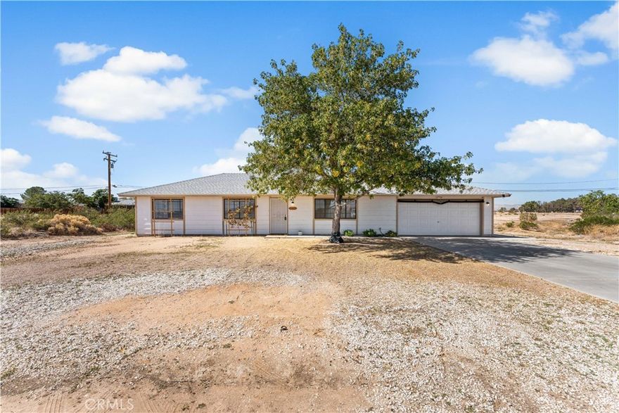 Tucked away in a quiet neighborhood at the edge of town, this charming 3-bedroom, 2-bath home offers the perfect blend of warmth and space. Step inside and you'll instantly fall in love with the rustic feel, highlighted by a cozy fireplace that serves as the centerpiece of the living room. The laminate vinyl flooring throughout adds a modern yet comfortable touch. The galley-style kitchen offers plenty of cabinetry and counter space, with a dining area that flows seamlessly into the living room—perfect for family meals or casual gatherings. The spacious primary bedroom provides room for large furniture and includes an ensuite bathroom for added convenience. One of the standout features of this home is the attached sunroom—an ideal space for lounging, working out, or entertaining guests year-round. Step outside to discover a massive backyard with endless potential. Whether you dream of adding a pool, building an outdoor kitchen, or creating your own garden retreat, there's plenty of room to make it your own. If you're looking for peaceful living with a spacious lot and charming character, this home is a must-see!
