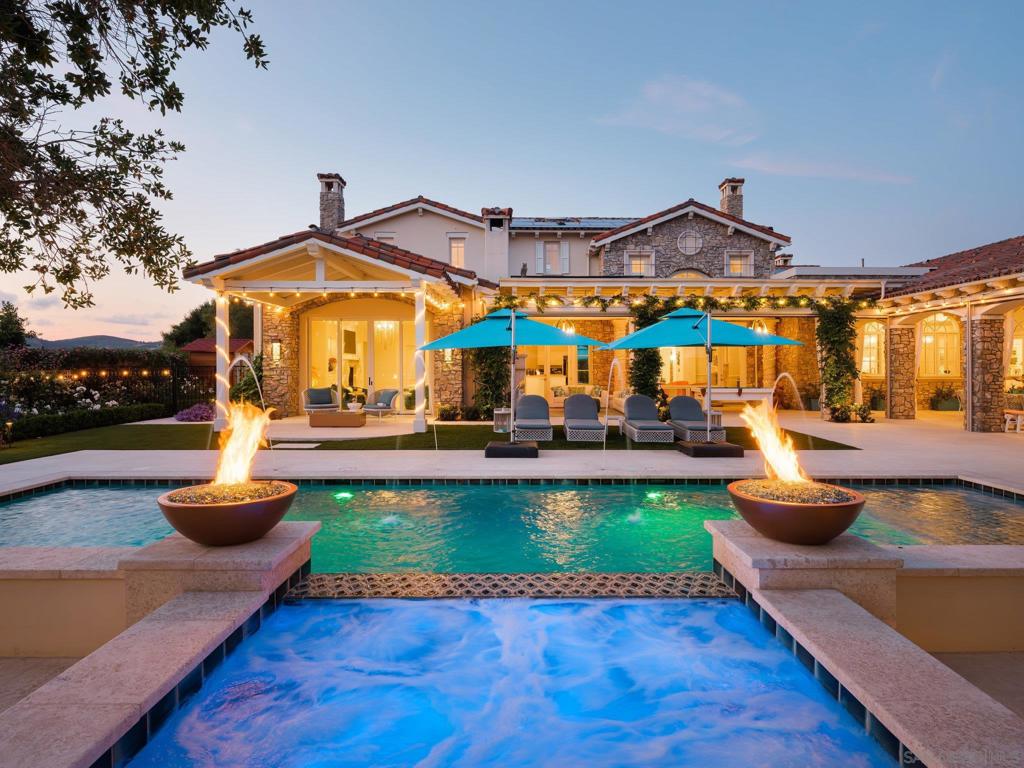 Now offered fully furnished and with Bridges Golf Membership! Perched on a private south facing lot within 24-hour guard gated Rancho Santa Fe Community of The Bridges. This fabulous 6 bedroom, 6 bath family compound almost 3 years and $4.8M in the making represents an ideal combination of upscale resort amenities and custom design. The glamorous blend of designer upgrades, top notch construction, incredible attention to detail and state-of-the-art technology translates into a luxurious and intimate environment. This new and refreshed family compound features a generous master suite, decadent master bath with a “one of a kind” lady’s wardrobe closet and private patio for epic sunsets. The open floor plan flows seamlessly from the front courtyard to the report style backyard. Formal dining & living rooms and his & her office circulate off the elegant entrance foyer. The family area features a gourmet quality yet family style kitchen that opens into a spacious family/great room with wet bar, wine room and Professional grade media room. Both formal and informal spaces open to heated covered patios overlooking the resort backyard. An outdoor cabana kitchen, kids play area, sauna and pool bath compliment the southwest facing private pool and spa.