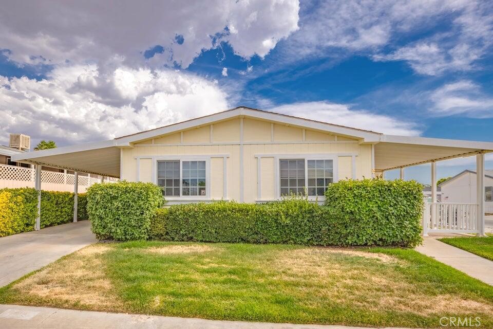 **Discover Spacious Comfort in a Welcoming Community!** Step into this well maintained triple wide mobile home featuring **3 generously sized bedrooms** and **2 full bathrooms**, offering ample space for you and your loved ones. Nestled in a charming owner-occupied park, this home promises a tranquil lifestyle with all the conveniences you need. The open floor plan seamlessly connects the living, dining, and kitchen areas, making it perfect for hosting family gatherings or simply relaxing at home. The **dedicated laundry room** adds practicality to your daily routine, keeping everything neat and organized. Outside, you'll find a **private carport**, ensuring your vehicles are protected from the elements, while still leaving room for additional storage. The home is surrounded by lush landscaping, creating a peaceful and inviting atmosphere. Whether you're looking for comfortable living or downsizing, this home is a perfect blend of comfort, convenience, and community. **Don't miss the opportunity to make it yours!**