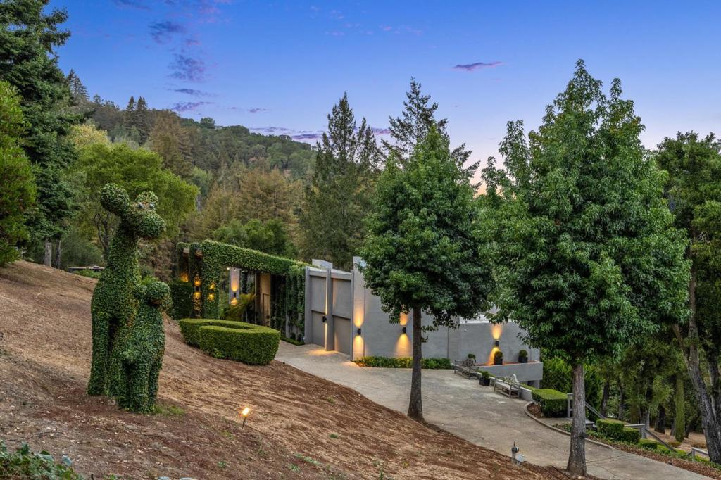 Modern Design on 6.3+ Gated Acres with SF Bay Views! Escape to a magical setting with close-in convenience on over 6.3+ acres with sweeping views out to the San Francisco Bay. The home is decidedly modern with sleek architectural lines and signature walls of glass that take full advantage of the views. The open arrangement of rooms is sophisticated and contemporary across varying levels and wings. All around, the grounds are captivating with terraced, level expanses of lawn, fields of lavender, and an amazing array of tulips that come alive in spring. There is a parterre garden inspired by the south of France, amazing vegetable gardens, orchards of fruit trees, a childrens play area, and a 4-stall barn all tied together with whimsical topiaries that add a touch of magic to the grounds. With options for a variety of lifestyles equestrian, vineyard, or just escaping the fast pace of Silicon Valley this unique property is very special indeed and just 5 minutes to Highway 280.