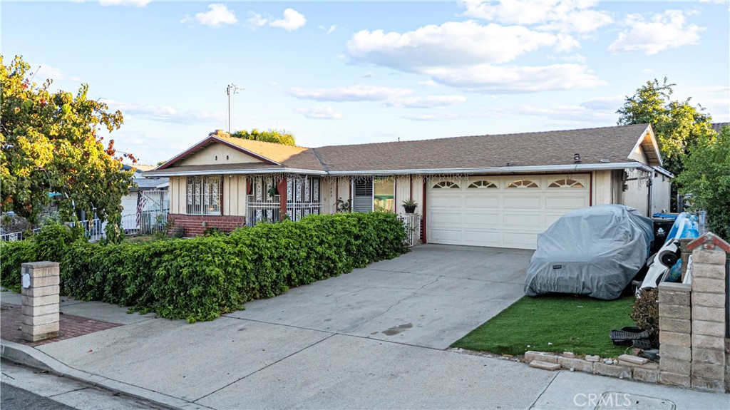 Welcome to this beautifully maintained 4-bedroom and 2-bathroom home in the heart of Pacoima! Built in 1969, this 1,660 sq ft residence sits on a generous 5,729 sq ft lot and is in MOVE-IN-CONDITION. The living room, informal dining area, and primary bedroom feature VAULTED CEILINGS with decorative black beams, creating an open and airy feel. The living room also boasts a charming brick fireplace, perfect for cozy gatherings. Furthermore, the home features RECESSED LIGHTING throughout. Natural light fills the living area, which flows seamlessly into the formal dining space—perfect for entertaining. The kitchen is a chef’s dream with RECESSED LIGHTING, ABUNDANT CABINETS, QUARTZ COUNTERTOPS with TILE BACKSPLASH, and an adjacent INFORMAL DINING AREA for casual meals. The spacious primary bedroom boasts ample closet space and a recently REMODELED BATHROOM with a mirrored vanity and glass-enclosed shower. The three additional bedrooms are spacious, each featuring large closets and SHUTTER BLINDS for privacy. Additional features include CENTRAIL AIR AND HEAT, an attached 2-car garage with a functional laundry area, and plenty of storage. Step outside to enjoy a large backyard with an enclosed patio, ideal for outdoor gatherings. Conveniently located near Costco, major shopping centers, schools, Hansen Dam Recreational area and golf course, and multiple freeways for an easy commute. Don’t miss your chance to call this Pacoima gem your new home!