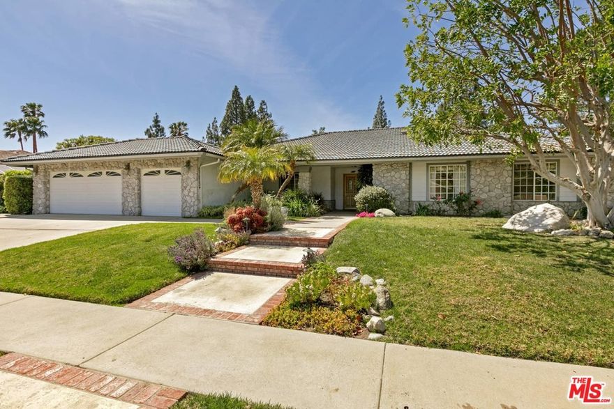 Look no further than this 4BR/3BA River-Rock home located on a peaceful and quiet street sitting on an enormous almost half an acre. From the moment you open the front door you will be greeted by a wide-open floor plan with high vaulted ceilings and dual living rooms including wet bar and fireplace.  Sun pours in from the double French doors in the living rooms creating the stage for indoor/outdoor living. The enormous backyard is the real show-stopper with fenced river-rock/pebble-tec pool/spa, small sport court, RV access, a place for a fire pit, and large grassy area for endless opportunity to enjoy spending time with your family. With the power lines subterranean, the backyard views are uninterrupted allowing for expansive views of the jaw-dropping Santa Susana Mountains. The charming kitchen has an eat-in area allowing for you and your family to enjoy the start and end to each day together.  The master suite has a large walk in closet, while all rooms have ample closet space and storage. Other features include: Solar Panels, 3 car garage, large attic, and hardwood floors. Dont sit back, this private retreat awaits you!