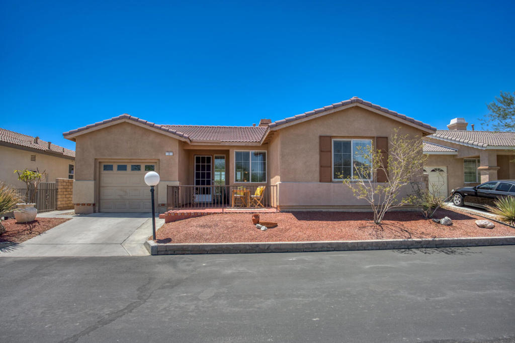 Move-in ready 3 bed, 2 bath single level home located in the desirable Desert Willows 55+ Community is ready to be made yours! Offering great curb appeal with front courtyard to enjoy, Solar Panels, Smart Home Features including an EV Tesla Solar charger, Smart Thermostat, and Smart Doorbell! The interior is open and spacious with a neutral paint scheme, hardwood flooring in the main living areas, tile floors in the kitchen, and carpet in the bedrooms. The living room has a fireplace and flows into the updated kitchen with wood counters, tile backsplash, beautiful pendant lighting, recessed lights, and included stainless steel appliances! The primary bedroom offers a private ensuite with dual sink vanity and a walk-in shower. There is also a full-size hall bathroom for the 2 secondary bedrooms to share, and a laundry room with additional storage space and including washer and dryer complete the home. Enjoy the private backyard with mountain views, and no maintenance landscaping/rockscape. There is a pergola to relax under. This home has an attached 1-Car Garage, and residents also get to enjoy an assortment of community amenities and events including a pool, spa, tennis court, pickleball, fitness center, banquet facilities, card room, and more! Conveniently located near shopping, dining, and not too far from the 10 Fwy. Schedule your private tour today!