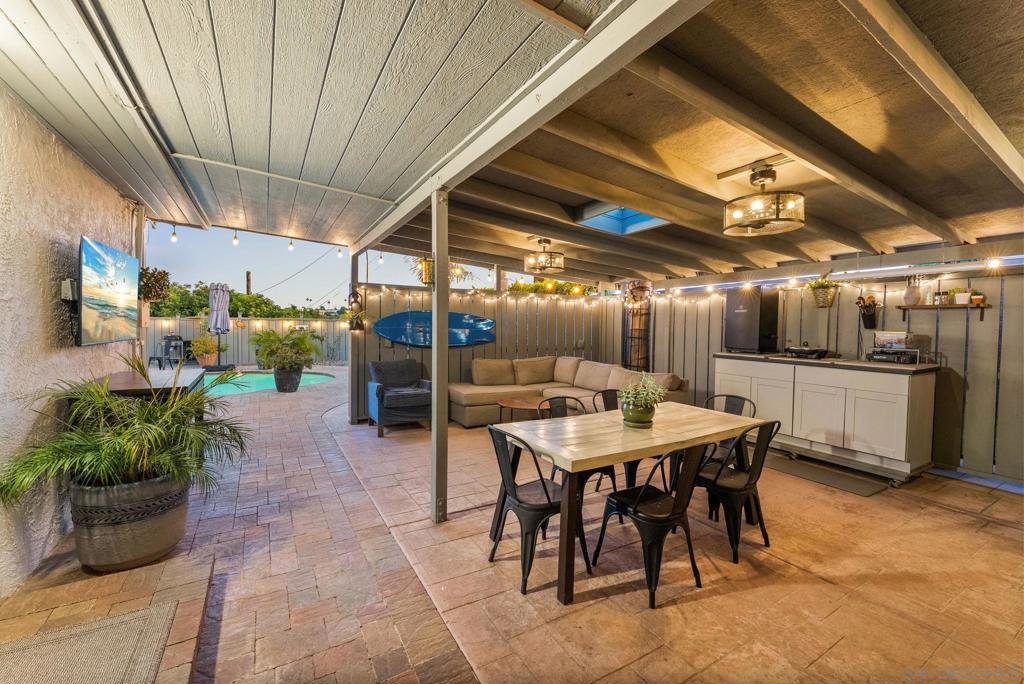 First time on the market in nearly 30 years! This lovingly maintained 3-bed, 2-bath home has been filled with unforgettable memories and is ready for its next chapter. While the interior offers a thoughtfully updated 1,008 sq ft, the true magic lies in the incredible outdoor living space. Step outside to your private backyard oasis.. featuring a refreshing pool, extended deck, shaded pergola, and an expansive covered entertainment area complete with a refrigerator, TV, ceiling fans, storage, and custom countertops. Whether it’s game day, summer BBQs, or quiet evenings under the lights, this space was made for year-round enjoyment. Low-maintenance pavers stretch from the carport through the yard, framed by dozens of mature palms and ambient evening lighting. Inside, enjoy shutters throughout, recessed lighting, a soaking tub in the shared bath, and a walk-in shower in the primary ensuite. Located just one block from Maryland Elementary and 2 minutes to the 8 freeway via Lake Murray Blvd, this gem blends charm, comfort, and unbeatable lifestyle.