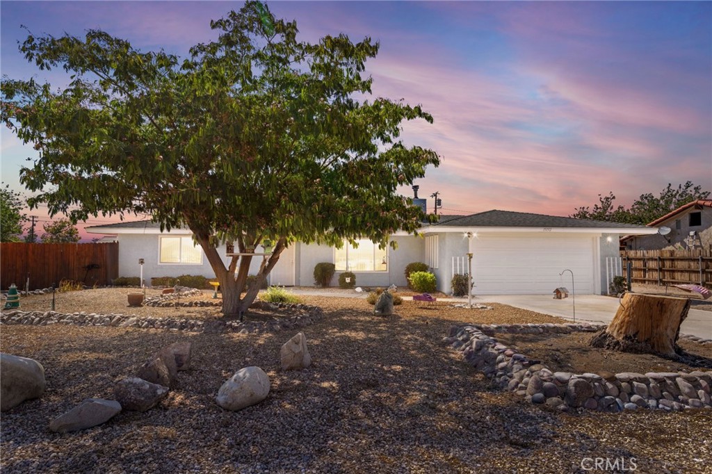 Welcome to this beautifully updated three-bedroom, two-bathroom home nestled in the heart of Apple Valley's peaceful desert community. This thoughtfully designed residence features a split floor plan with an open concept that seamlessly connects the living spaces, creating an ideal environment for both daily living and entertaining guests. The home showcases numerous recent improvements that enhance both comfort and efficiency. A freshly painted exterior welcomes you to a property that has been meticulously maintained, complete with a new roof, new windows, and an updated guest shower. Inside, you'll appreciate the modern conveniences of smart technology, including a wireless garage door, thermostat, and stove that bring contemporary living to this charming desert retreat. The living room serves as the heart of the home, featuring attractive laminate flooring and a cozy wood-burning insert that provides warmth during cooler desert evenings. The completely fenced property offers exceptional outdoor living opportunities with a covered patio perfect for year-round enjoyment and a spacious yard that provides ample room for a future pool and recreational vehicles. Practical amenities include convenient recreational vehicle access and two electrical-equipped sheds for additional storage. The generous lot size truly sets this property apart, offering endless possibilities for desert enthusiasts who enjoy outdoor activities and entertaining. Located in a family-friendly neighborhood with easy access to local parks, shopping, and schools, this home combines the tranquility of desert living with modern conveniences. The established community provides a perfect balance of peaceful residential living while maintaining proximity to essential amenities and recreational facilities.